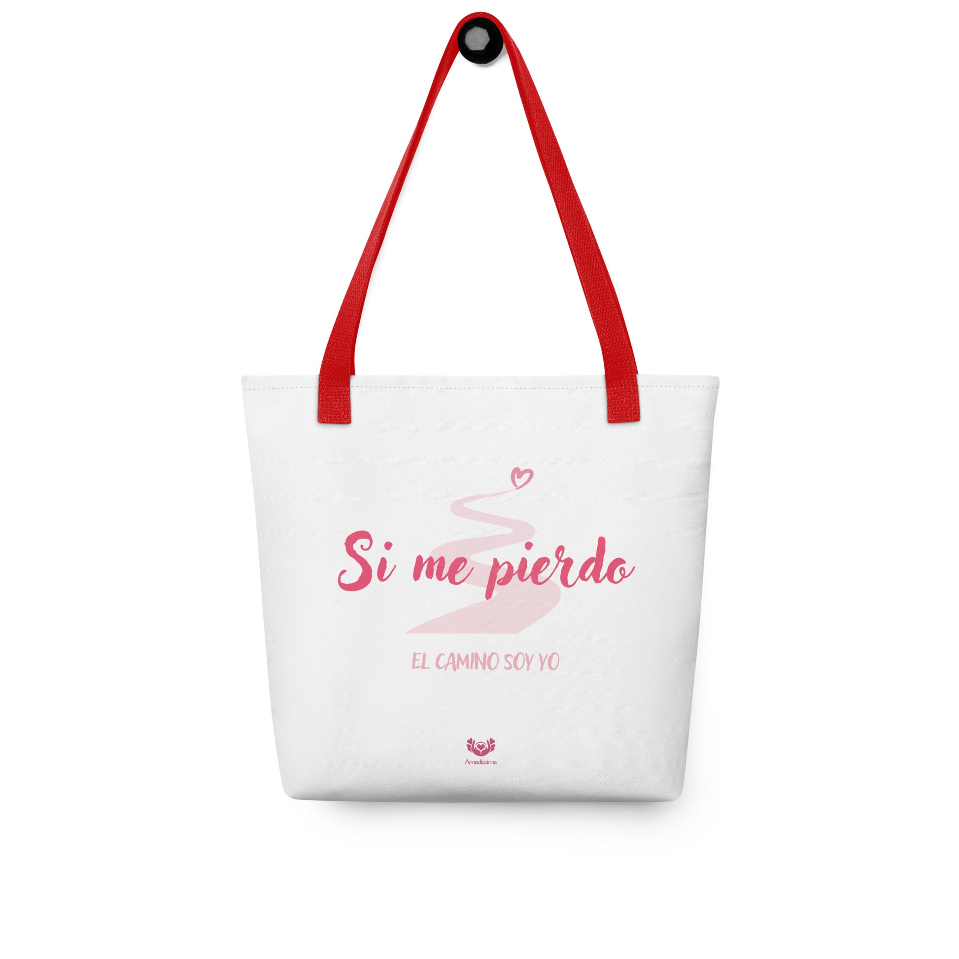 Bolsa de tela “Si me pierdo, el camino soy yo” con asa roja desplegada sobre fondo neutro